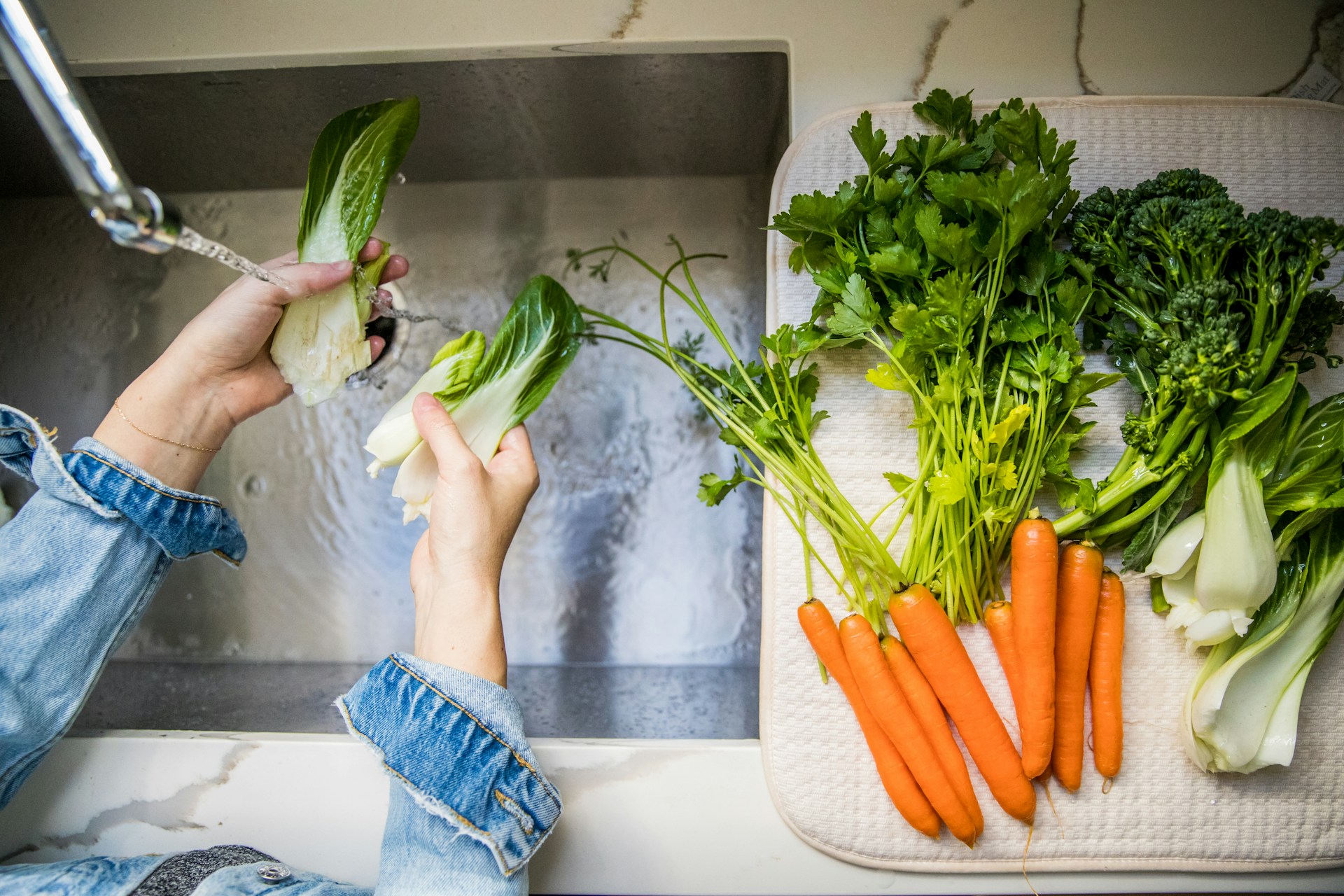 washing vegetables in the sink